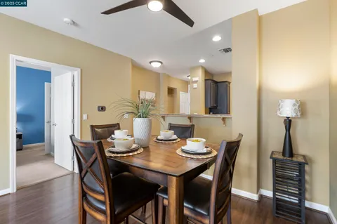 a living room with furniture wooden floor and a lamp