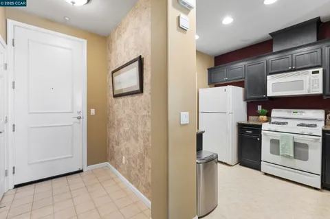 a kitchen with stainless steel appliances granite countertop a sink and a refrigerator