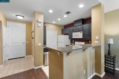 a kitchen with a sink a stove and cabinets