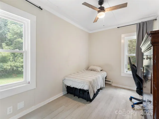 a bedroom with a bed and a flat tv screen