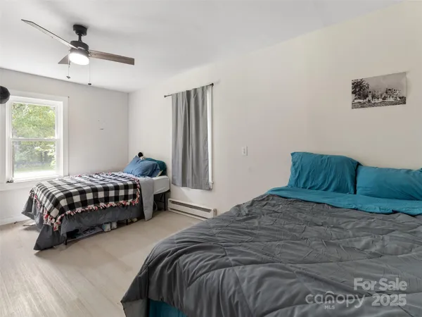 a bedroom with a bed lamp and window