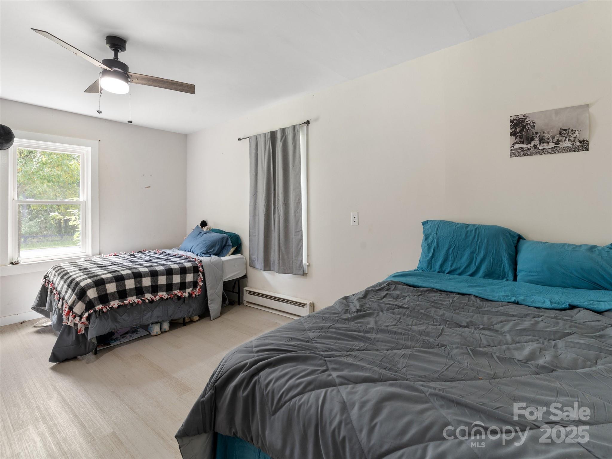 1343 Solen Williams Road Tryon, NC 28782 - Photo 15 of 17 a bedroom with a bed lamp and window