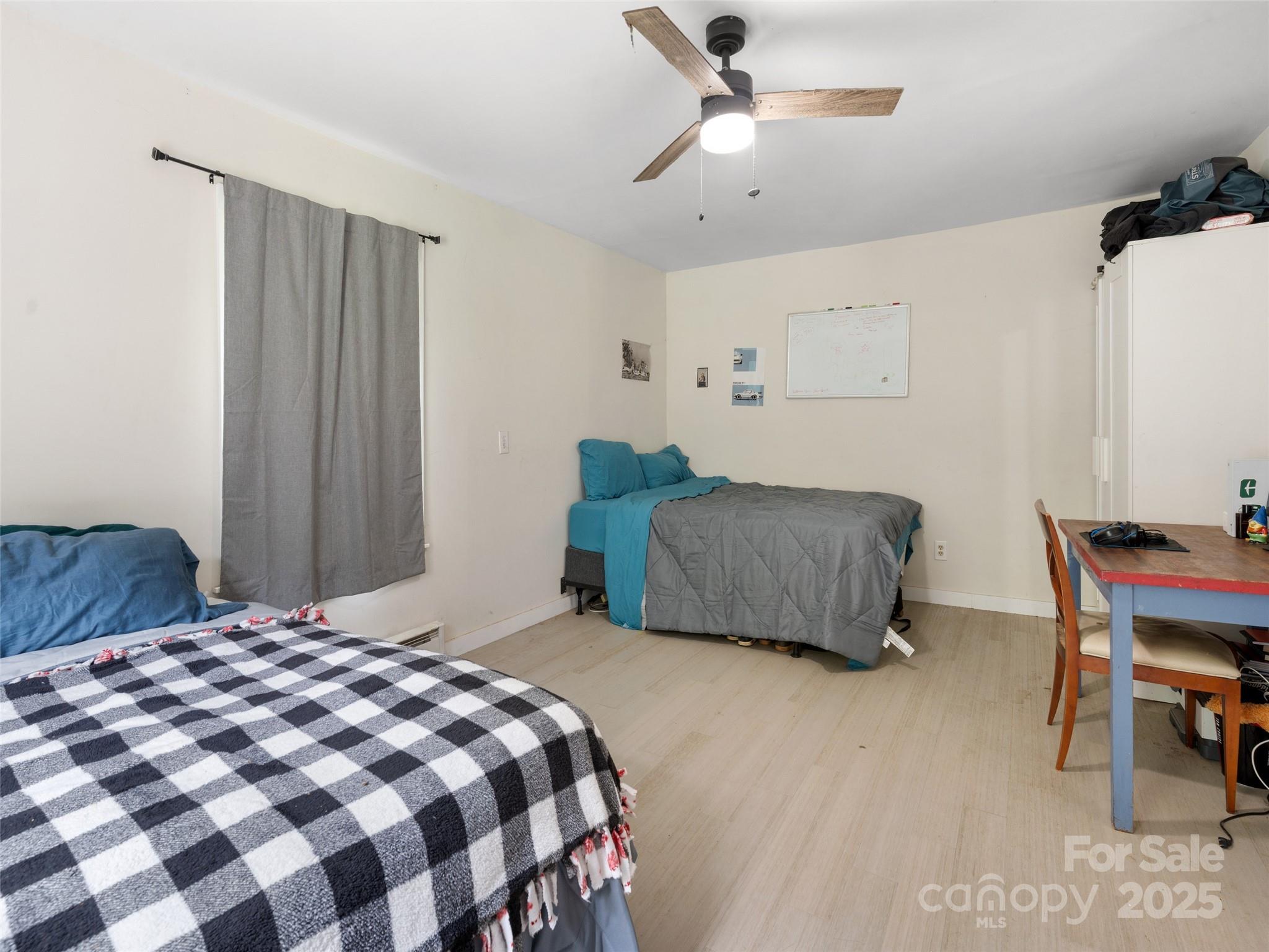 1343 Solen Williams Road Tryon, NC 28782 - Photo 16 of 17 a bedroom with a bed and a chair