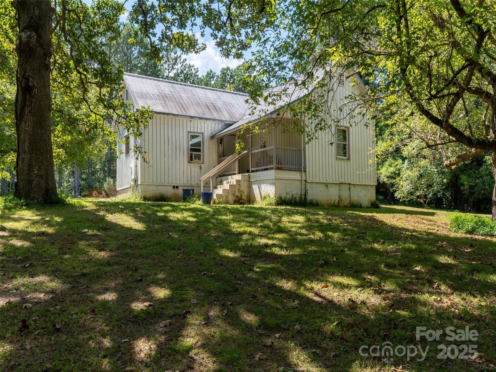 1343 Solen Williams Road Tryon, NC 28782 - Photo 3 of 17 a view of a barn in the middle of a yard