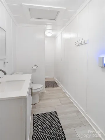 a bathroom with a sink a toilet and a mirror