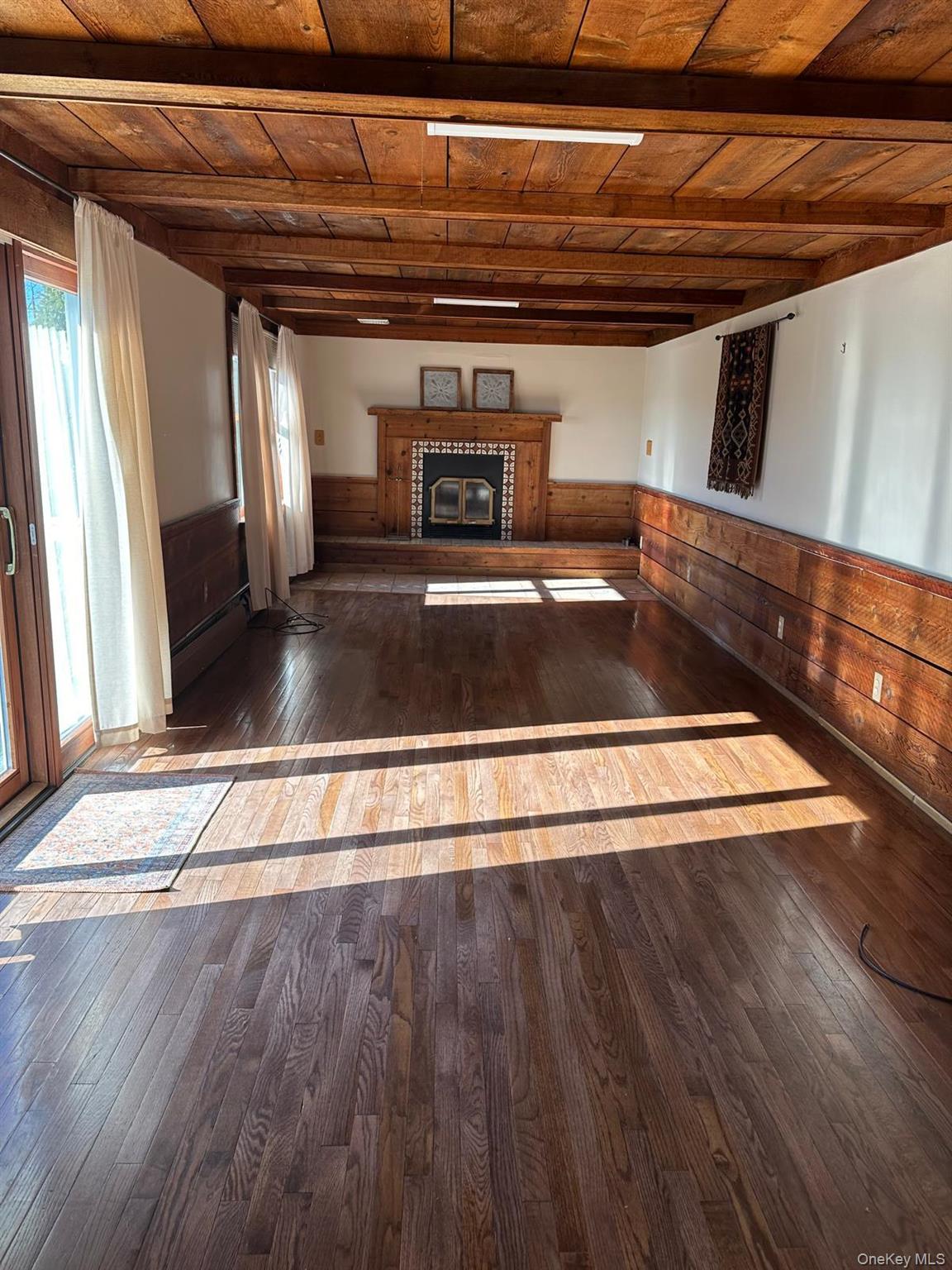 168 Pine Hill Road, Unit 1 Chester, NY 10918 - Photo 4 of 13 Living room with wooden detailing throughout, fireplace, hardwood floors, and beamed wood ceiling