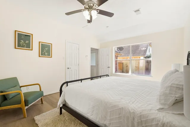 a bed room with a bed and chair