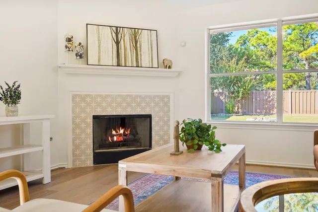 a living room with furniture a window and a fireplace