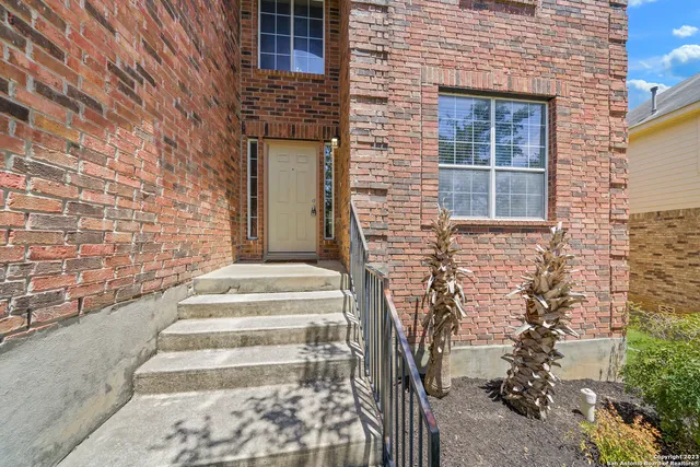 a front view of a house with a garden and entryway