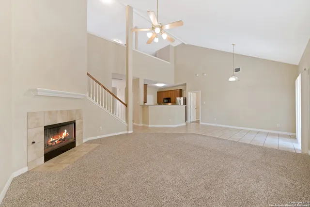a view of an empty room with fire place and a fireplace