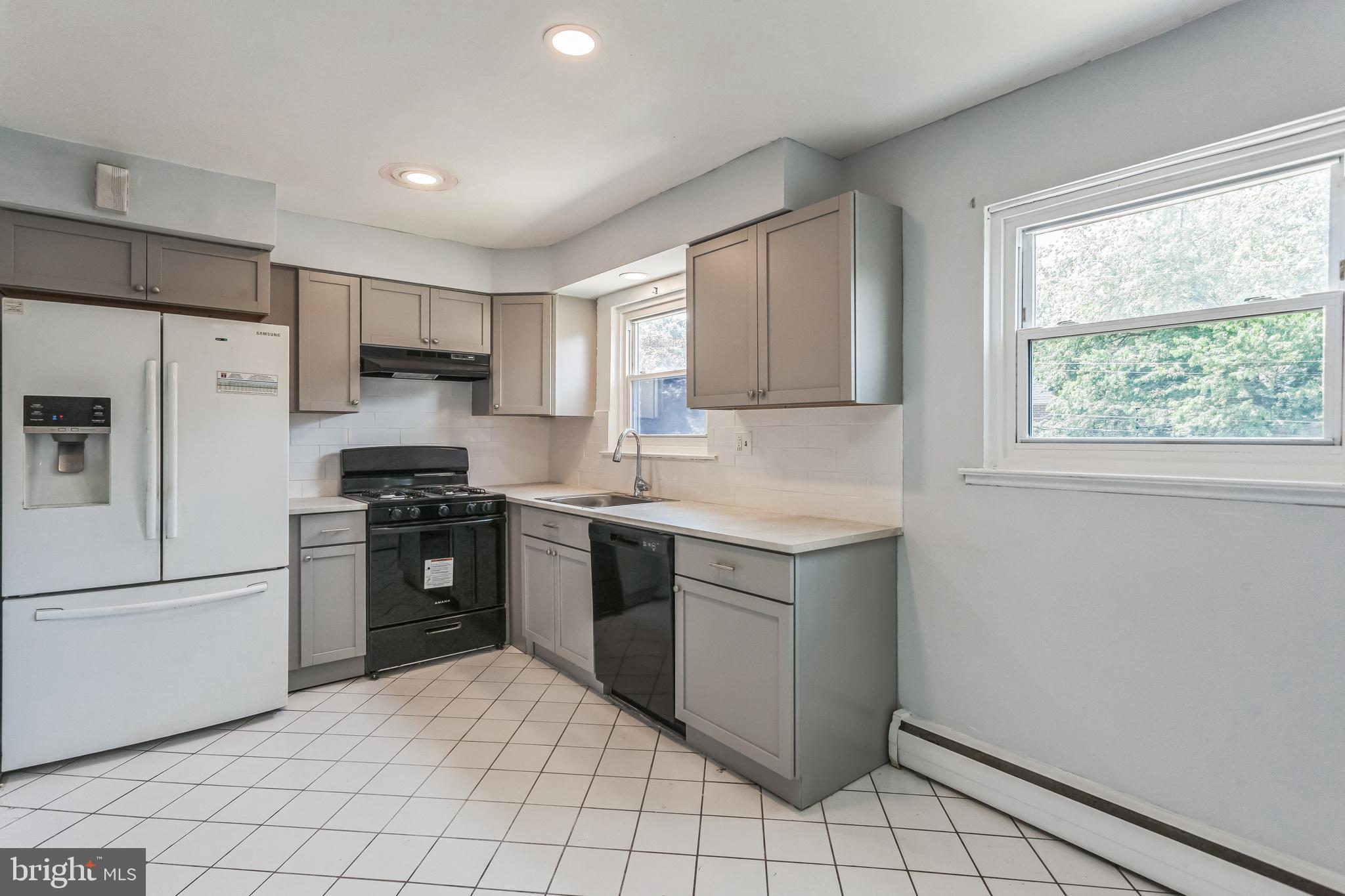 1125 Solly Avenue Philadelphia, PA 19111 - Photo 12 of 49 a kitchen with granite countertop a refrigerator stove top oven and sink