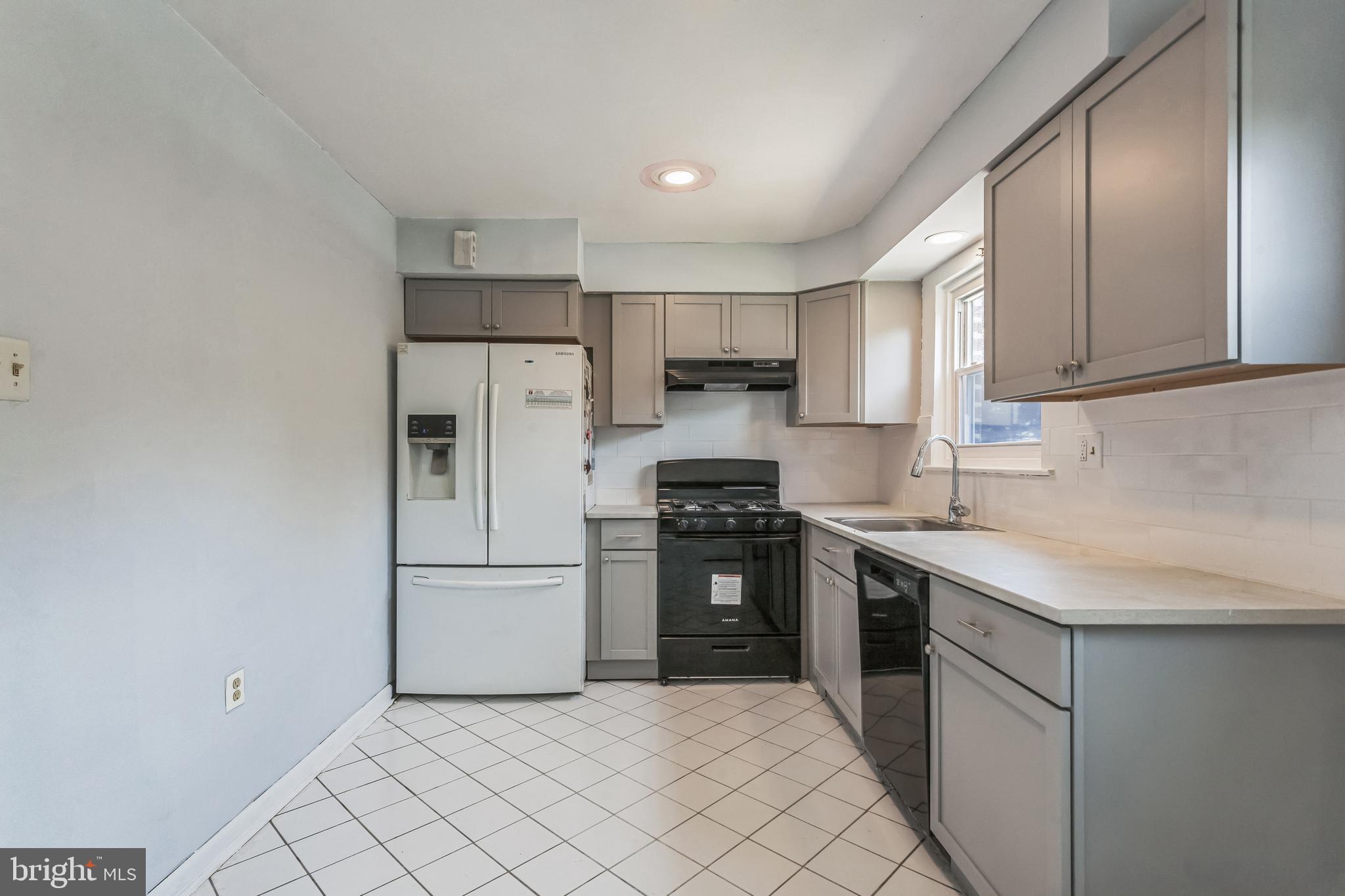 1125 Solly Avenue Philadelphia, PA 19111 - Photo 13 of 49 a kitchen with cabinets stainless steel appliances and a sink