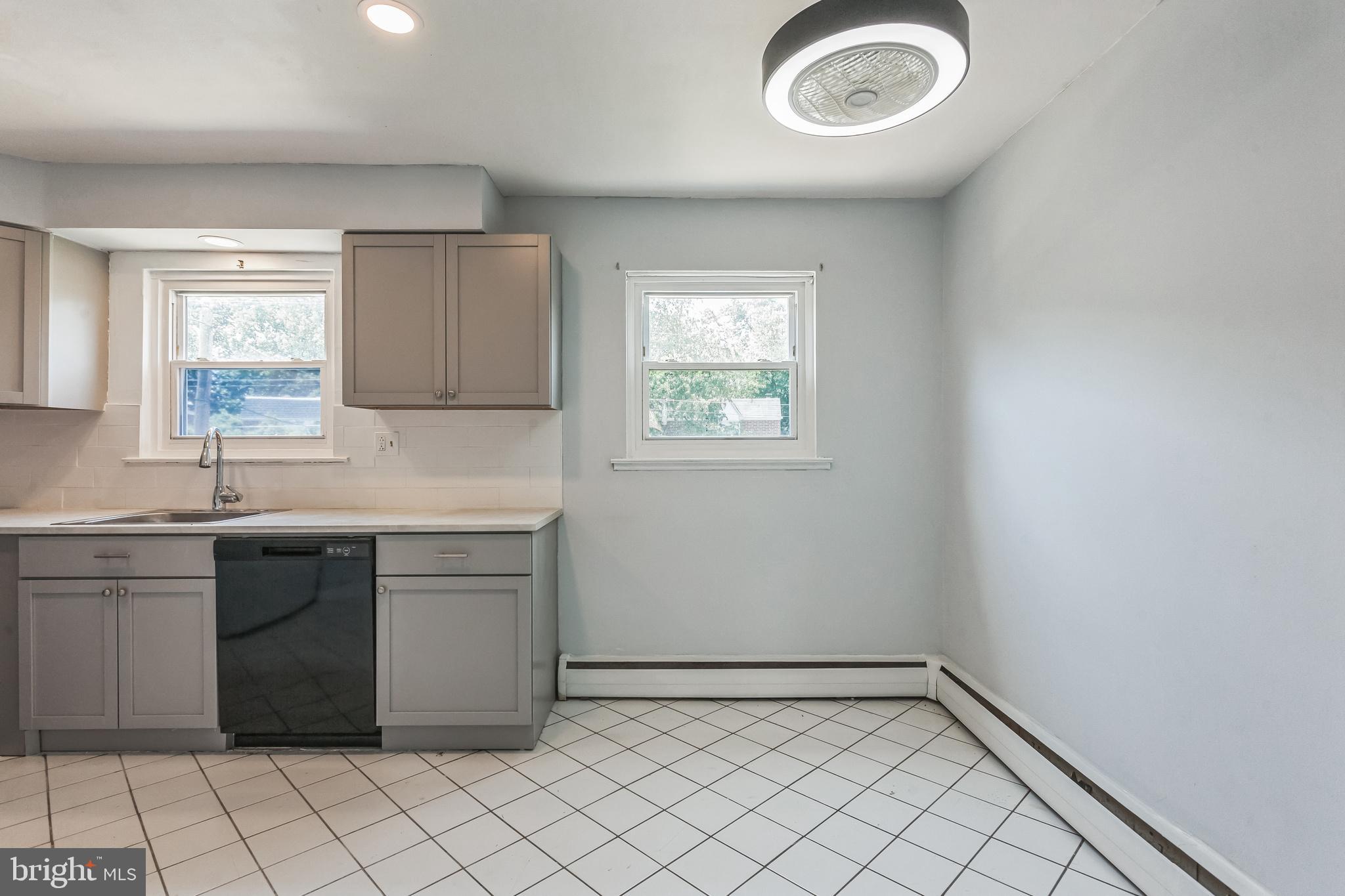 1125 Solly Avenue Philadelphia, PA 19111 - Photo 14 of 49 a kitchen with a stove a sink and a window