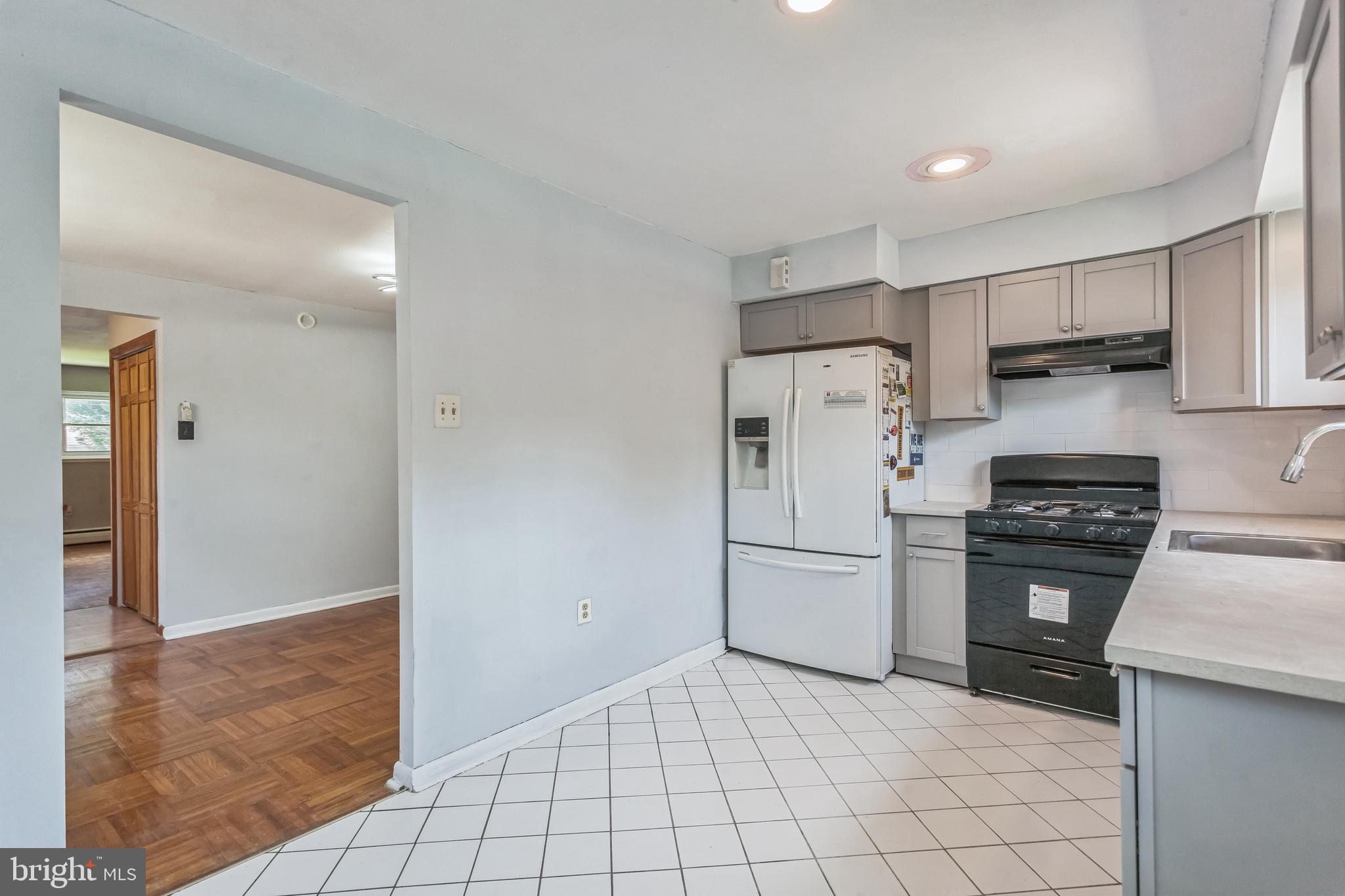 1125 Solly Avenue Philadelphia, PA 19111 - Photo 15 of 49 a kitchen with a stove a refrigerator and a sink