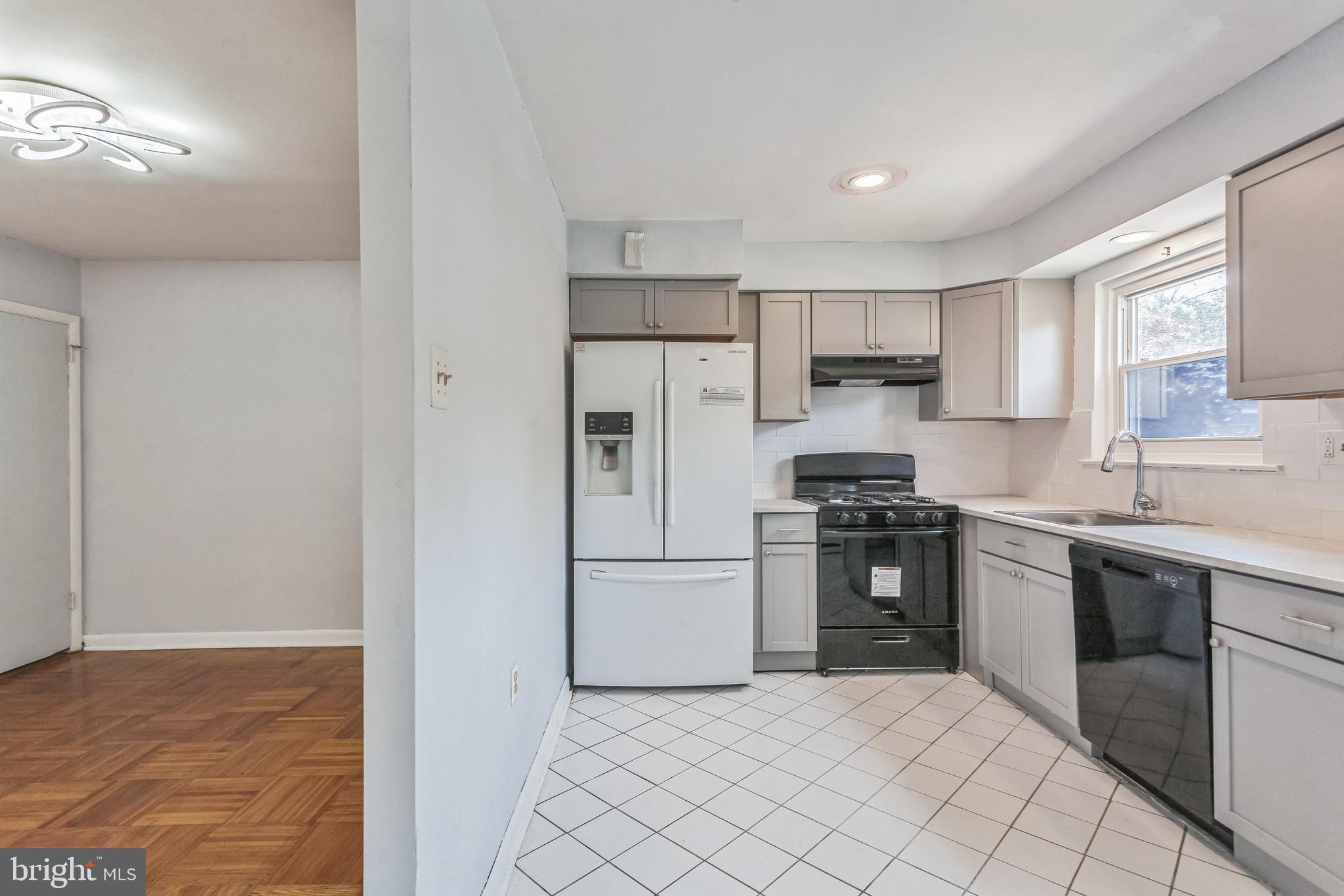 1125 Solly Avenue Philadelphia, PA 19111 - Photo 17 of 49 a kitchen with stainless steel appliances granite countertop a stove a sink and a refrigerator