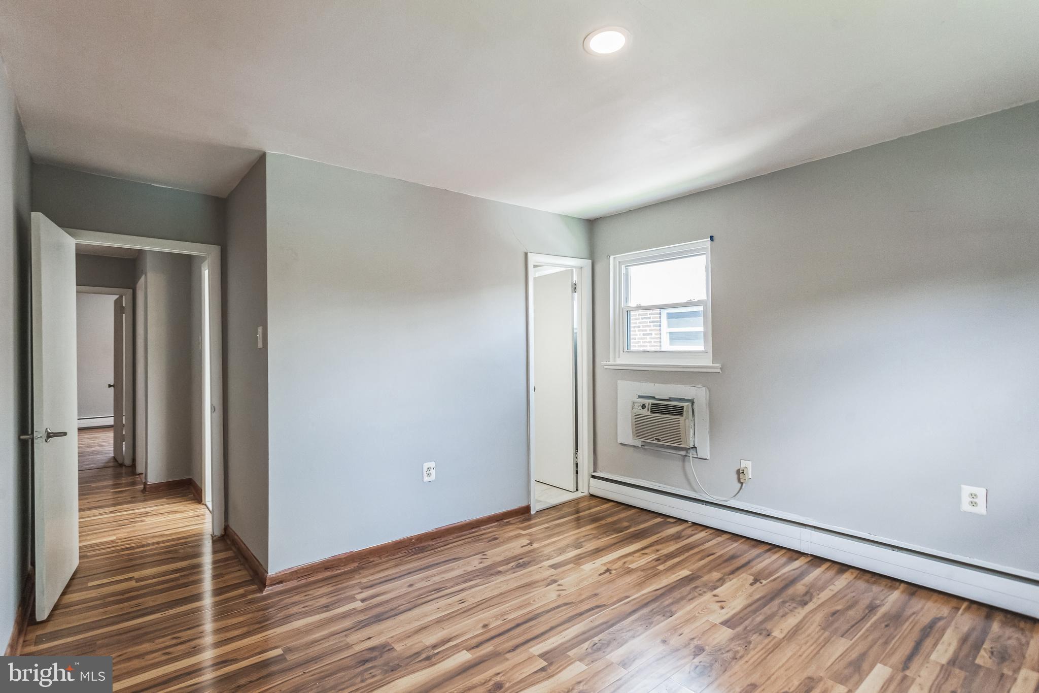 1125 Solly Avenue Philadelphia, PA 19111 - Photo 25 of 49 a view of an empty room with wooden floor and a window