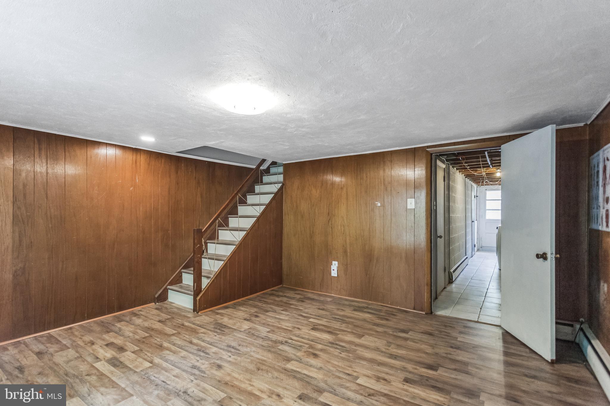 1125 Solly Avenue Philadelphia, PA 19111 - Photo 34 of 49 a view of an empty room with wooden floor and stairs
