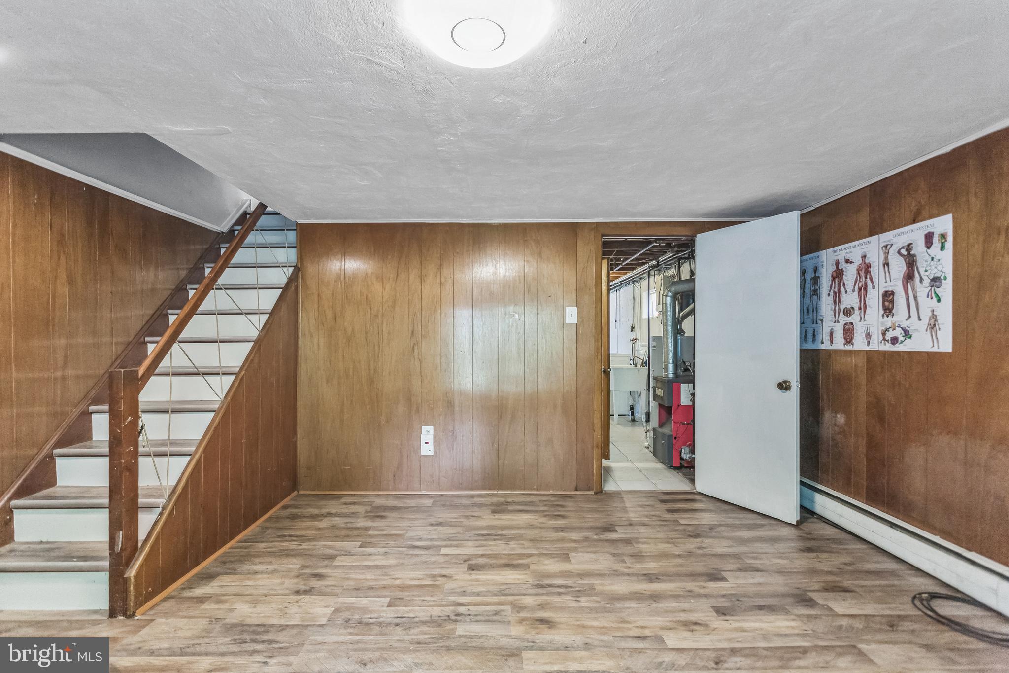 1125 Solly Avenue Philadelphia, PA 19111 - Photo 36 of 49 a view of an empty room with stairs and wooden floor