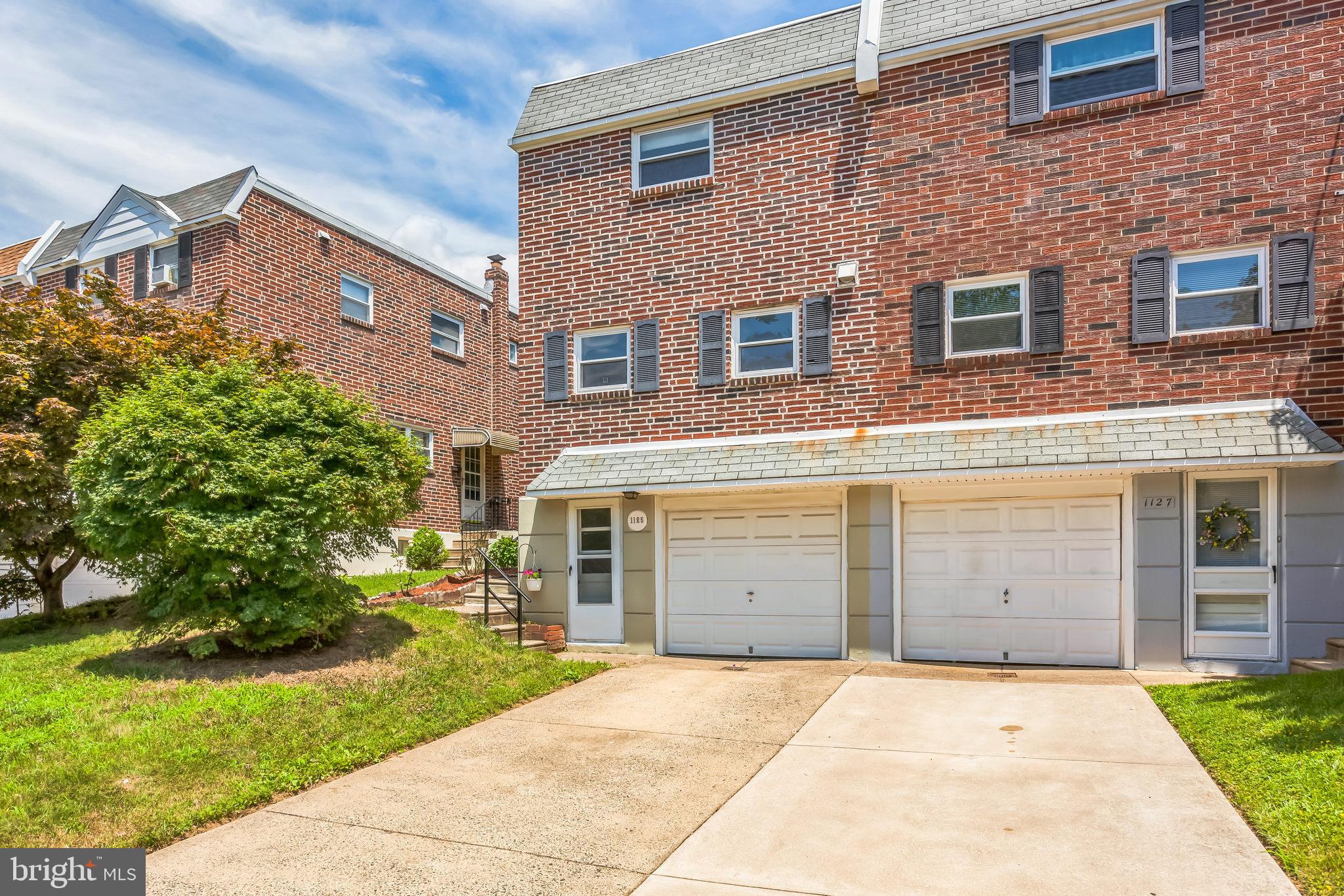 1125 Solly Avenue Philadelphia, PA 19111 - Photo 44 of 49 a front view of a house with a garden and garage