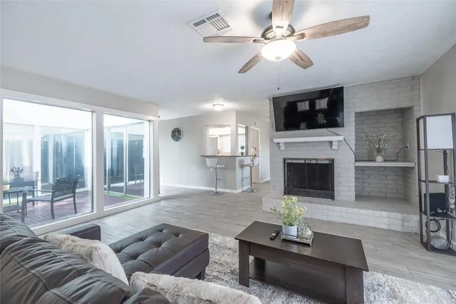 a living room with furniture fireplace and a flat screen tv