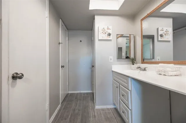 a bathroom with a sink a mirror and a shower