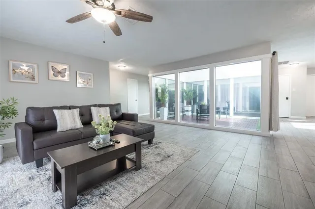 a room with wooden floor and potted plant