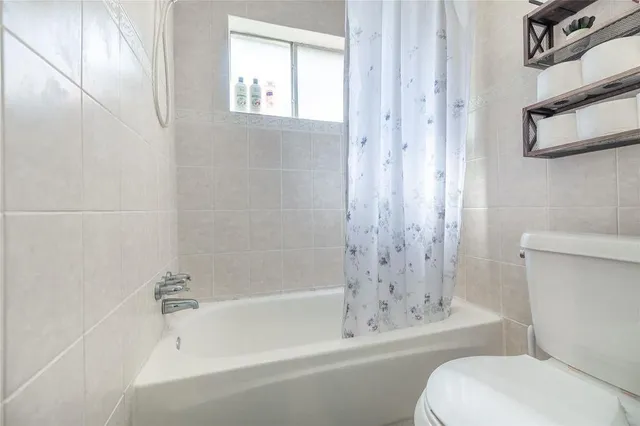 a bathroom with a toilet and a bathtub