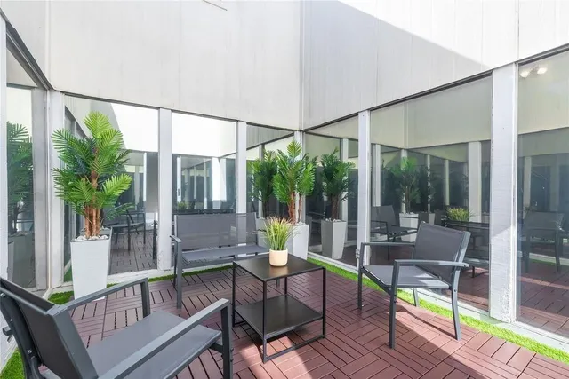 a view of a patio with a dining table and chairs