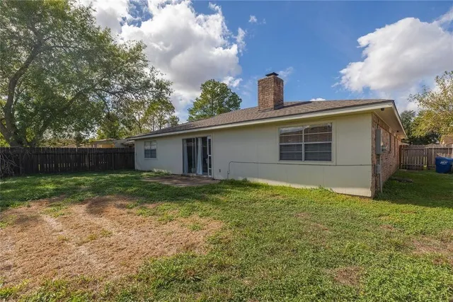 a view of a house with yard and a tree