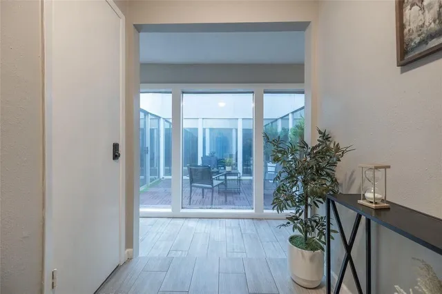 a room with wooden floor and potted plant