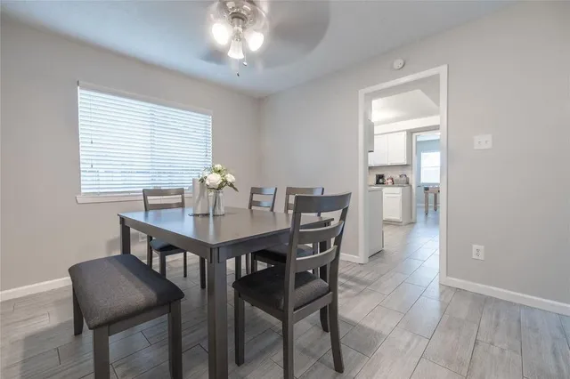 a view of a dining room with furniture and chandelier