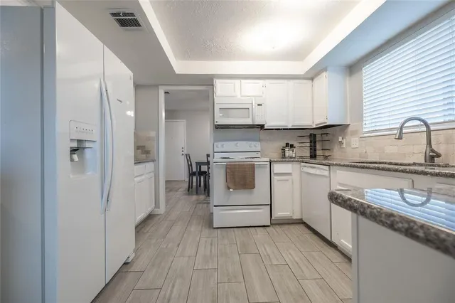 a kitchen with a sink stove and cabinets