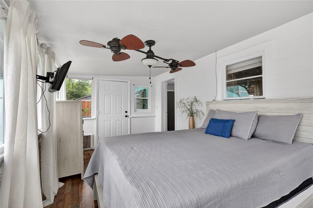 521 Michigan Street Mount Dora, FL 32757 - Photo 12 of 27 a bedroom with a bed and a chandelier
