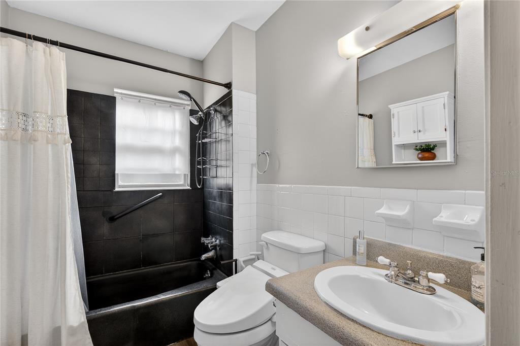 521 Michigan Street Mount Dora, FL 32757 - Photo 13 of 27 a bathroom with a sink toilet and shower