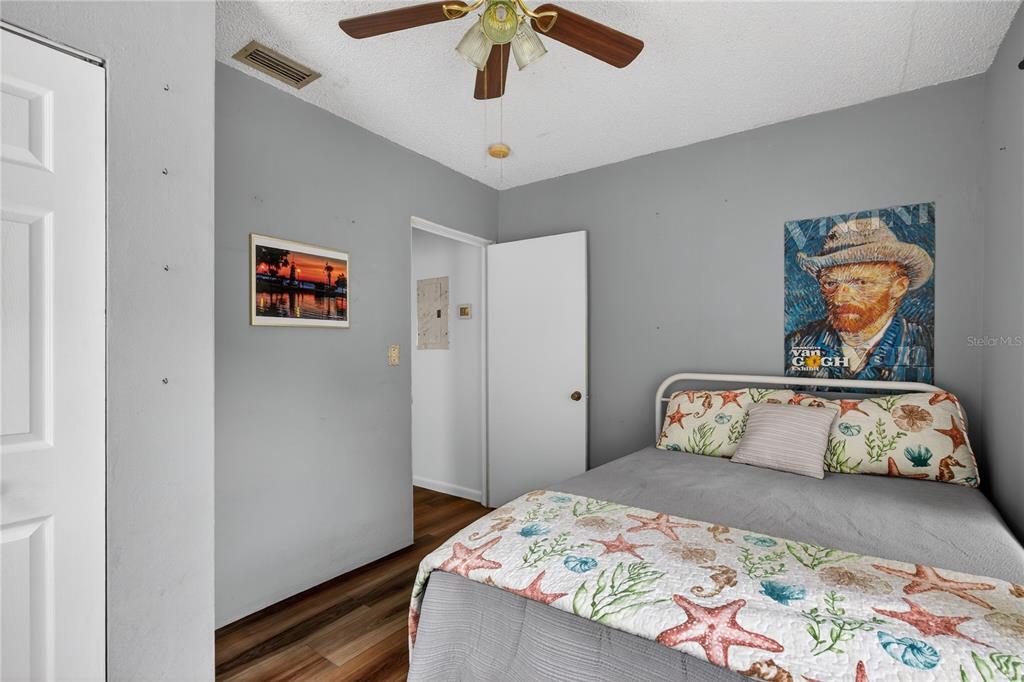 521 Michigan Street Mount Dora, FL 32757 - Photo 15 of 27 a bedroom with a bed and a painting on the wall