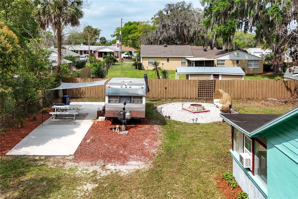 521 Michigan Street Mount Dora, FL 32757 - Photo 19 of 27 a view of a patio with table and chairs near a yard