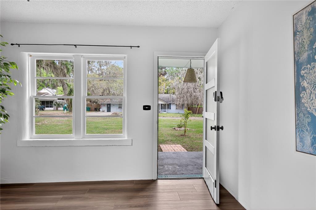 521 Michigan Street Mount Dora, FL 32757 - Photo 3 of 27 a view of an entryway with wooden floor and a livingroom