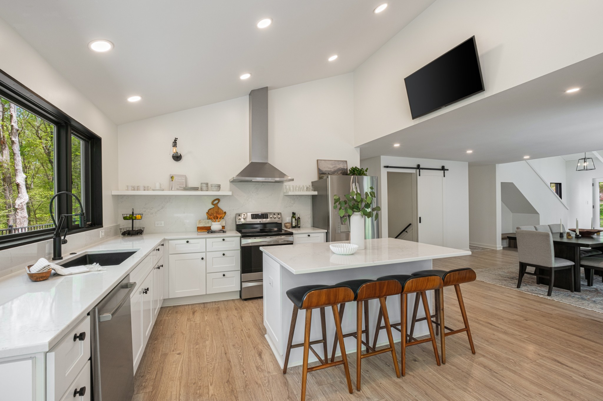 880 High Point Ridge Road Franklin, TN 37069 - Photo 11 of 51 a large kitchen with kitchen island a stove a sink a dining table and chairs