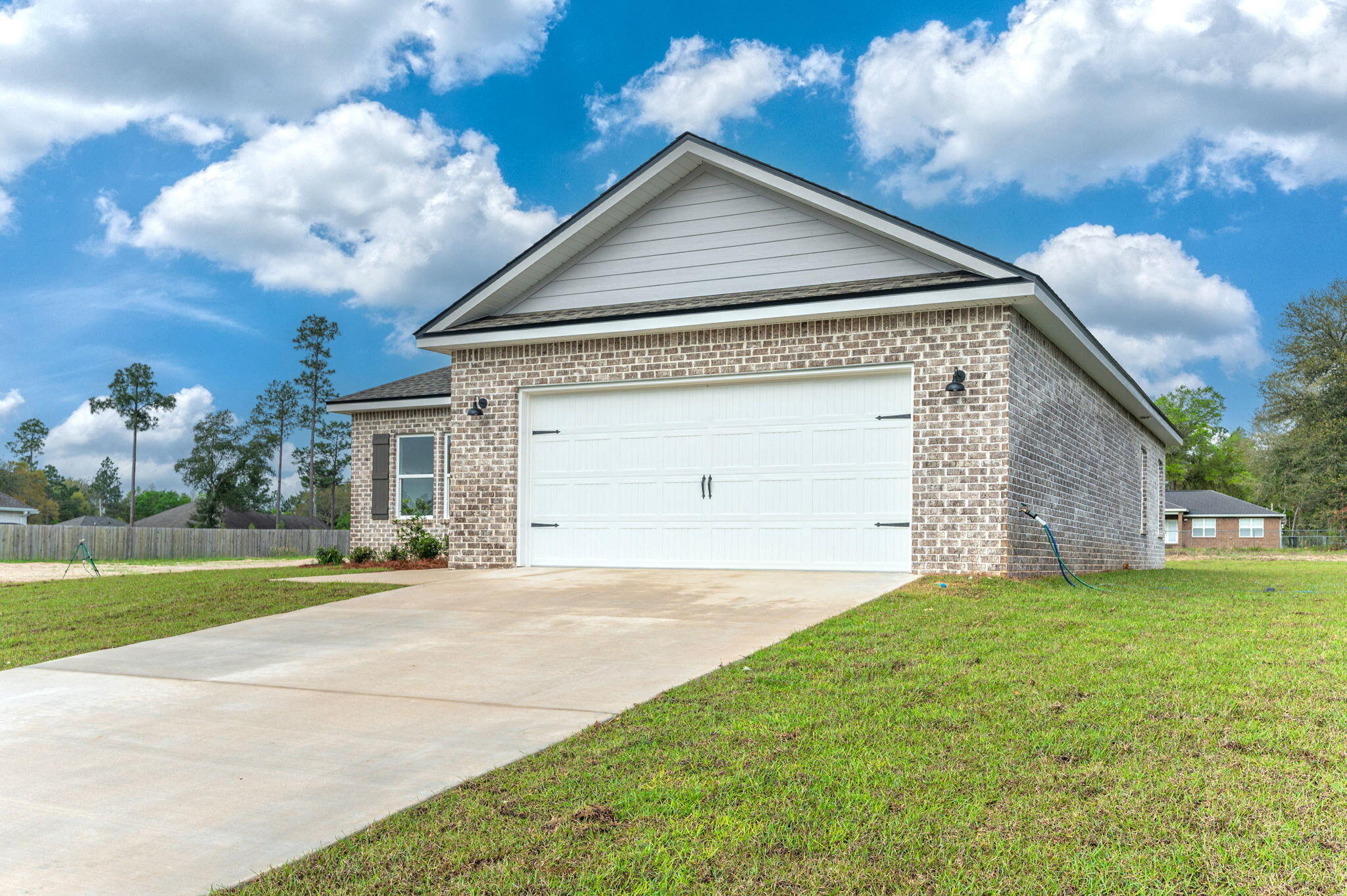 4083 Happy Trails Road Crestview, FL 32539 - Photo 3 of 38 a front view of a house with a yard and garage