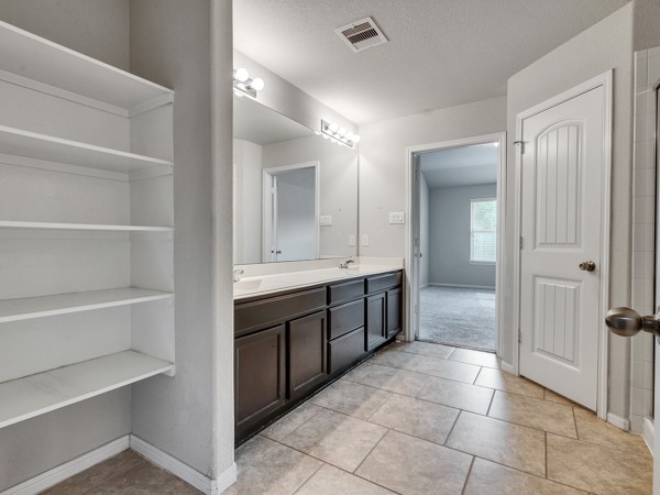 2939 Canadian Goose Lane Baytown, TX 77521 - Photo 27 of 48 a spacious bathroom with a double vanity sink a mirror and a bathtub