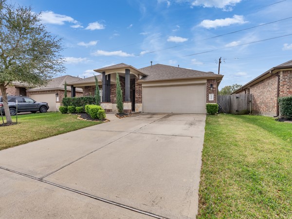 2939 Canadian Goose Lane Baytown, TX 77521 - Photo 46 of 48 a front view of a house with a yard and garage