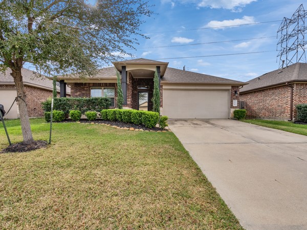 2939 Canadian Goose Lane Baytown, TX 77521 - Photo 6 of 48 This is a charming 3 bedroom single-story brick home with a bonus room and no back neighbors. It features a well maintained front yard with tasteful landscaping, and a driveway leading to a garage.