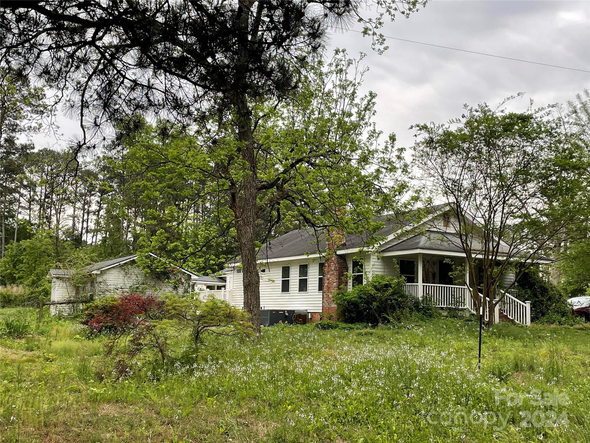64 Deaton Street Ruby, SC 29741 - Photo 2 of 23 a front view of a house with garden