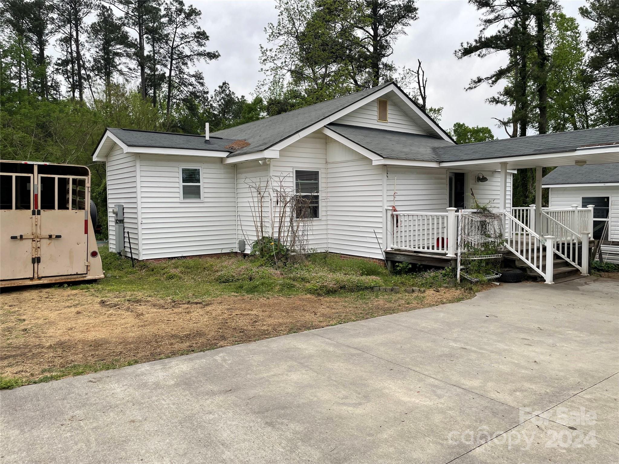 64 Deaton Street Ruby, SC 29741 - Photo 4 of 23 a view of a house with a yard and large trees