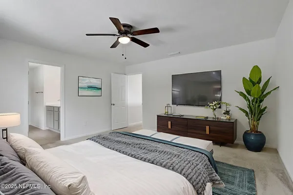a view of a livingroom with a ceiling fan and window