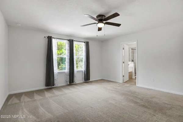 a view of a room with a ceiling fan