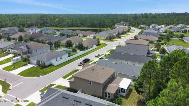 an aerial view of house with yard swimming pool and outdoor seating