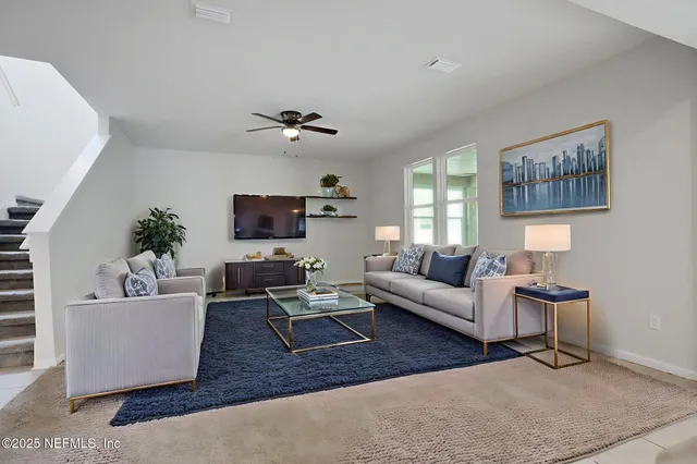 a living room with furniture and a flat screen tv
