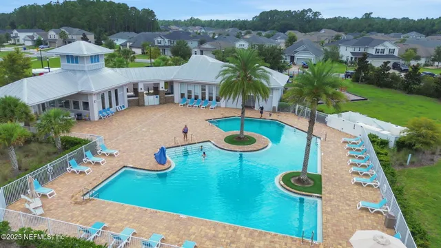 a backyard of a house with garden and outdoor seating