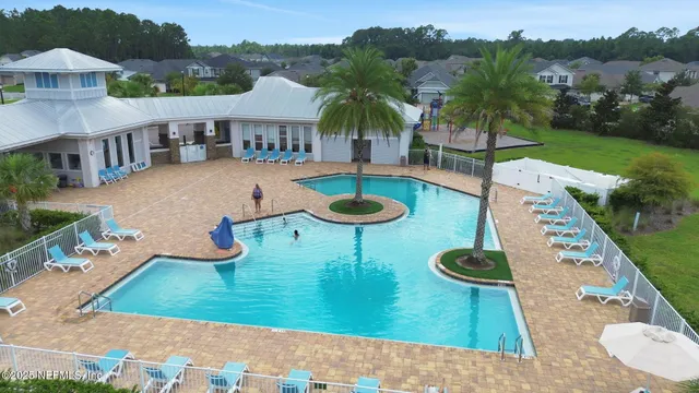 an aerial view of a house with outdoor space swimming pool and mountains